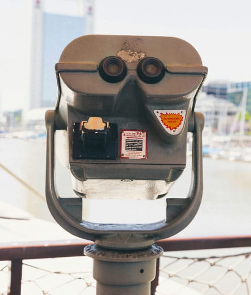 Coin-operated binocular viewer overlooking harbor and city skyline